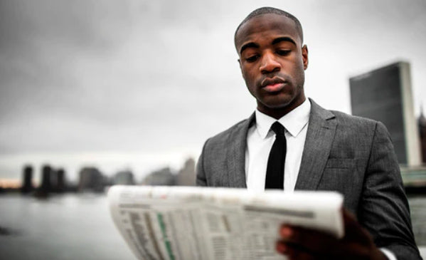 Black man reading newspaper